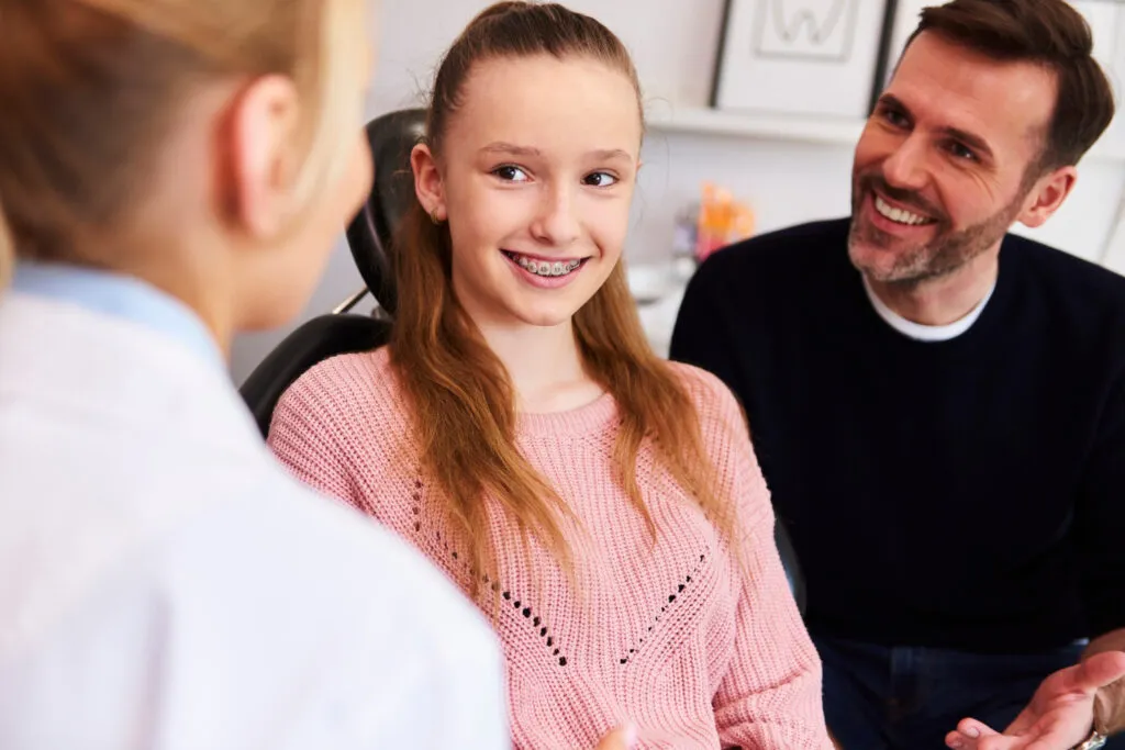 happy girl with her father while a detnal appointment