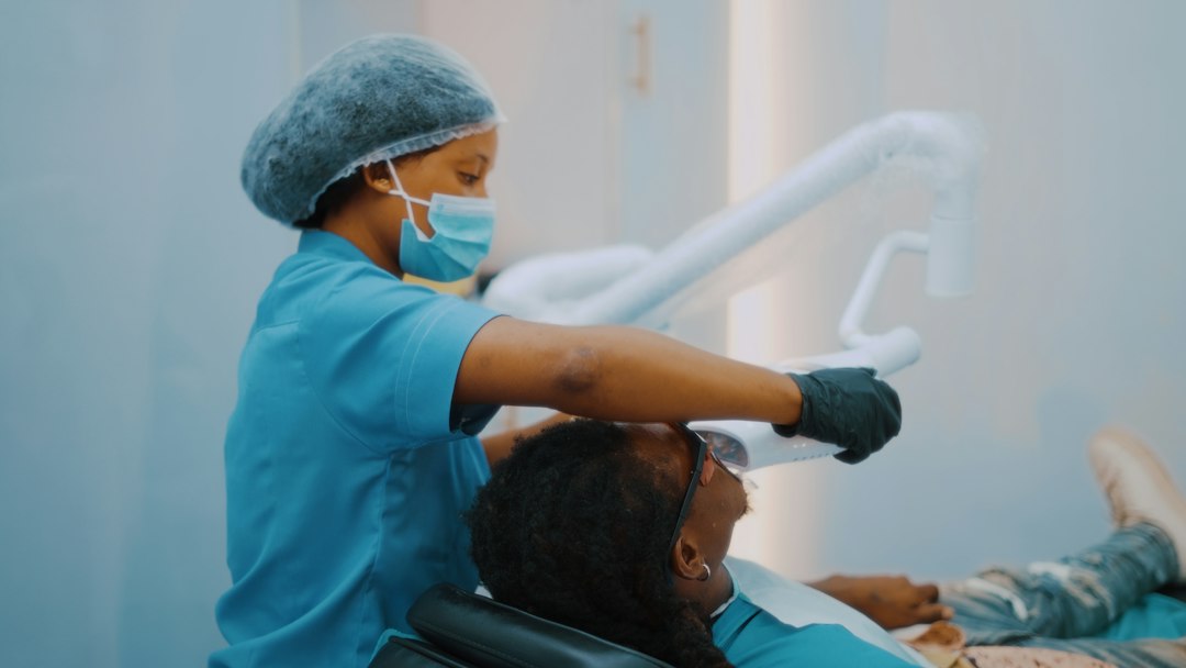 Dentist performing an oral exam on a patient