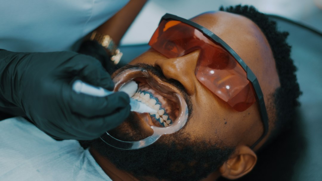 Man having his teeth cleaned by a dentist