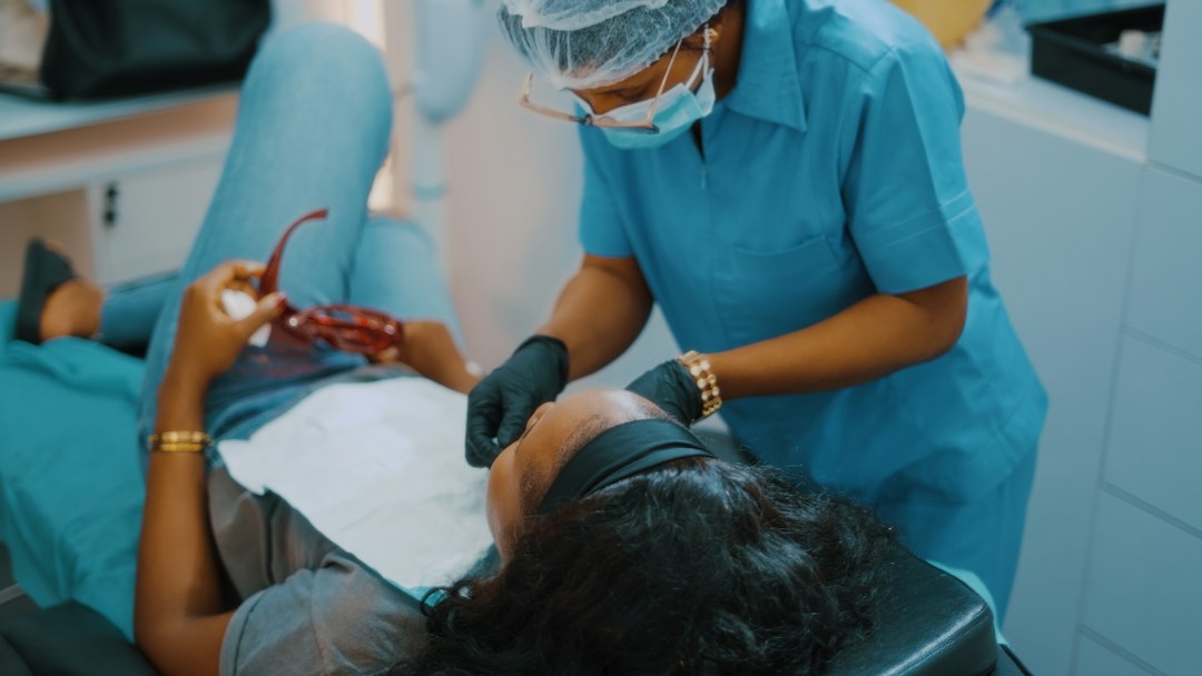Dentist examining a patient's teeth during an exam